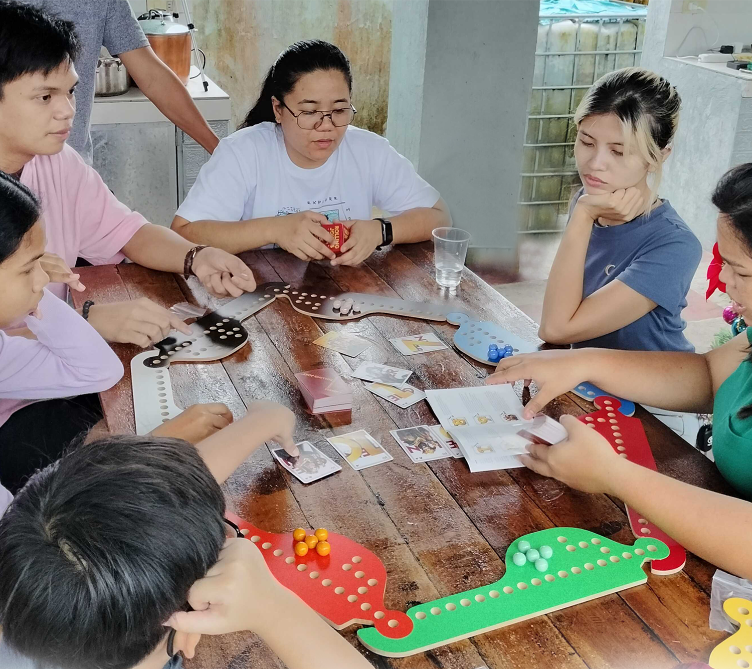 Eight people playing Rolling Jokers at a family gathering